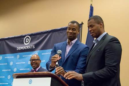 Jarron Collins (podium left) and first openly gay NBA player Jason Collins (podium right), twin brothers who have both retired from the NBA. LGBT Caucus Chair Earl Fowkles is standing behind them. LGBT Caucus. Pennsylvania Convention Center. (July 26, 2016) 