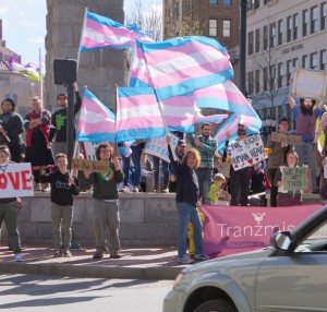 Asheville, North Carolina, USA - April 2, 2016: Colorful LGBT demonstration with protesters rallying support from passing cars in protest against North Carolina's HB2 Law on April 2, 2016 in downtown Asheville, NC